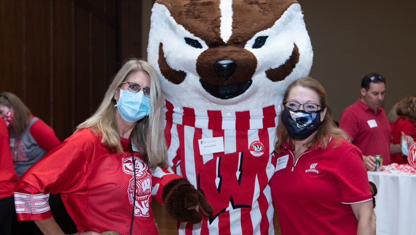 Bucky with two female alumni