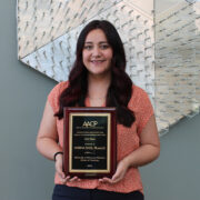 Marina Maes holding a LITE award for first place