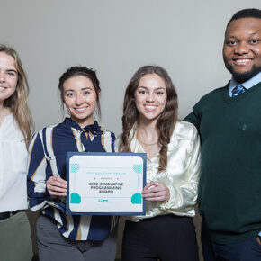 Natalie McCourt, Hope Schier, Lauren Glaza, and Michael Nome, holding "2022 Innovative Programming Award"