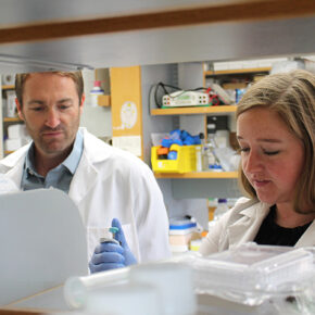 Warren Rose and Cecilia Volk working in the lab