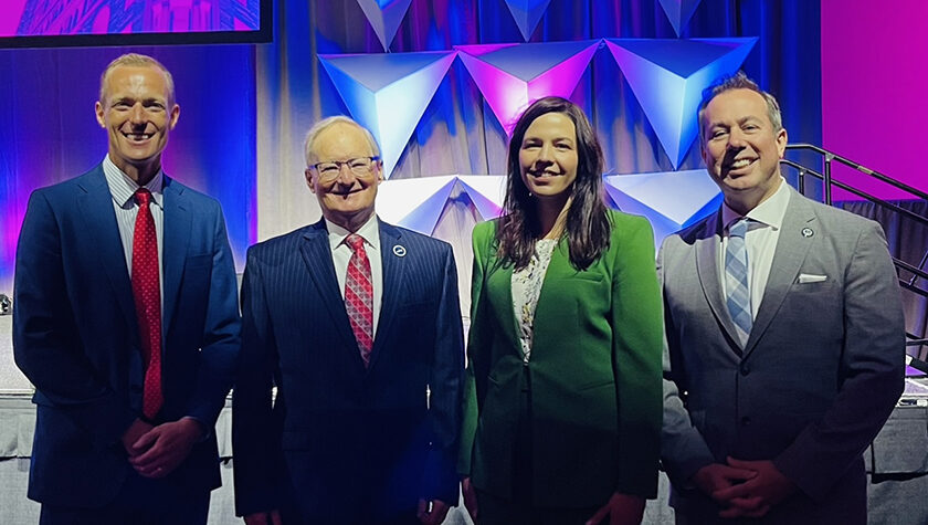 Jordan Dow, Tom Thielke, Kate Schaafsma, and Neil MacKinnon standing together after being inducted as Fellows