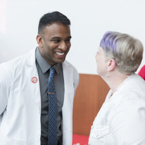 PharmD student Mathawan Balakrishnan receives his pin from Associate Professor Karen Kopacek. | Photo by Todd Brown