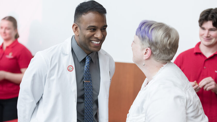 PharmD student Mathawan Balakrishnan receives his pin from Associate Professor Karen Kopacek. | Photo by Todd Brown