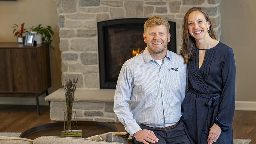 Jessica and Jesse Schaetzel pose by a fireplace