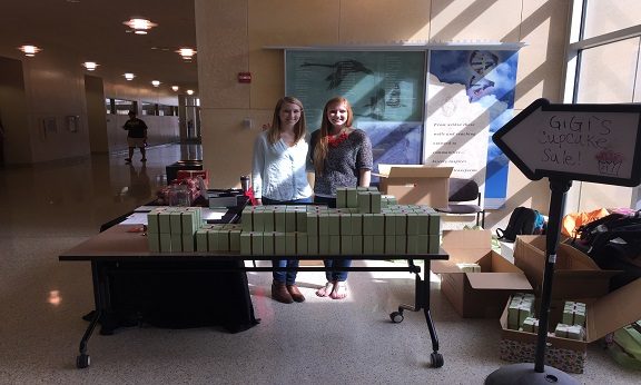 Kara Wischer and Emily Blaski running stand selling Gigi's cupcakes