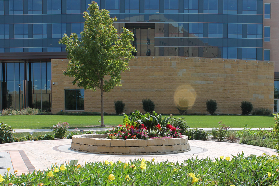 a picturesque view of the Rennebohm Healing Garden is surrounded by the legacy brick walk