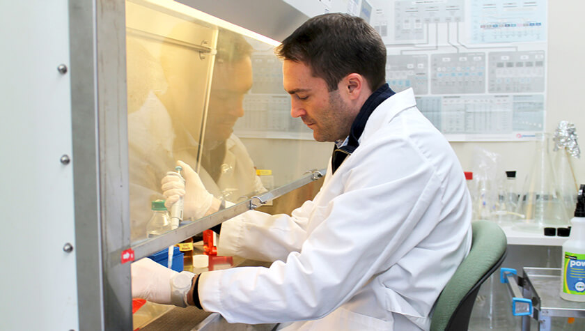Associate Professor Warren Rose in his lab working at fume hood