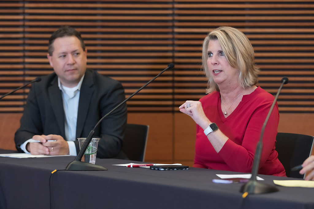 Brent Eberle and Debra Fluno sitting on a panel