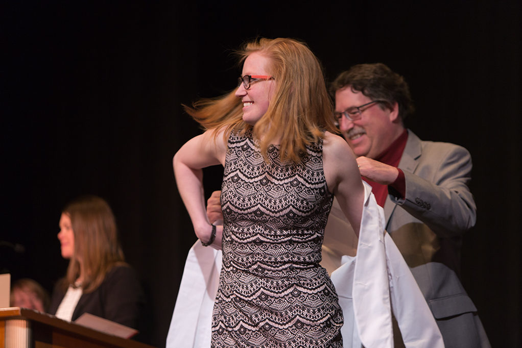 Students dress with the white coat to symbolize the achievement they have at the School.