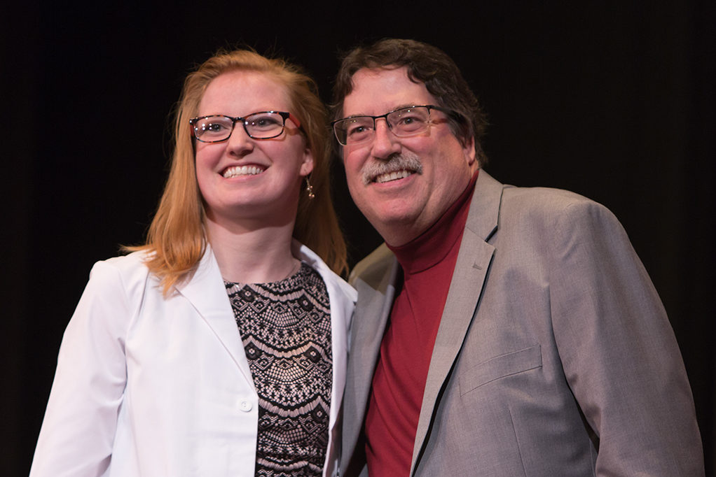 Students dress with the white coat to symbolize the achievement they have at the School.