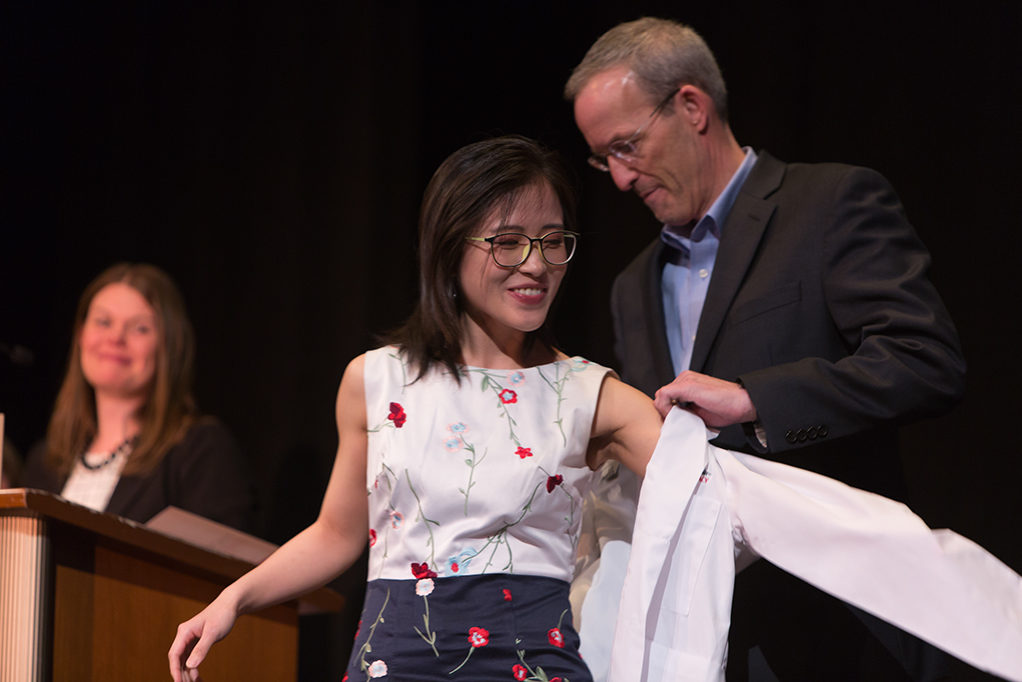 Students dress with the white coat to symbolize the achievement they have at the School.