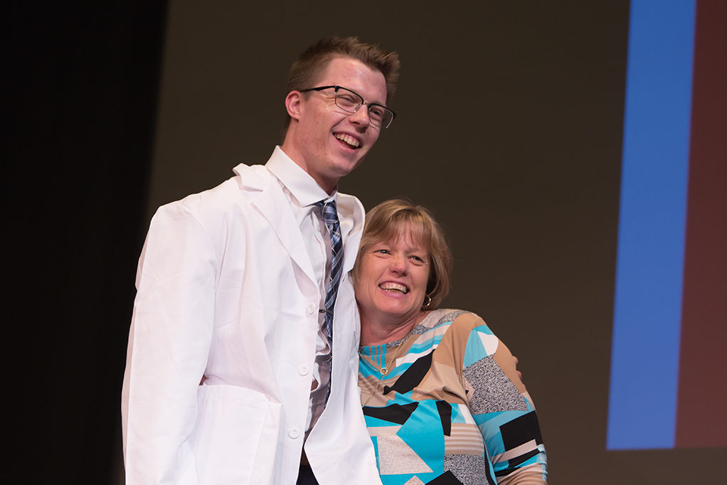 Students dress with the white coat to symbolize the achievement they have at the School.