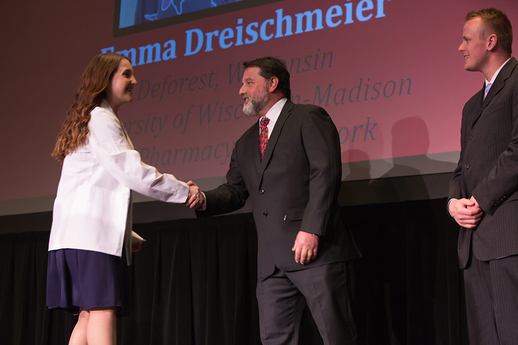 Students dress with the white coat to symbolize the achievement they have at the School.