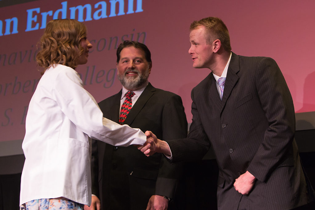 Students dress with the white coat to symbolize the achievement they have at the School.