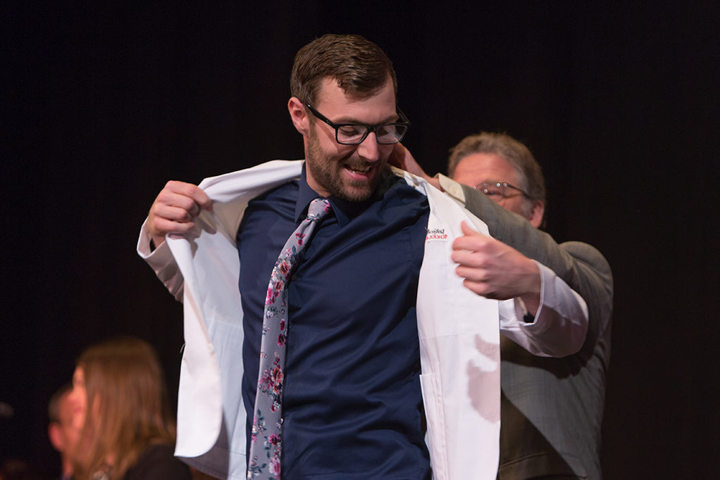 Students dress with the white coat to symbolize the achievement they have at the School.