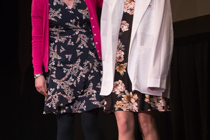 Students dress with the white coat to symbolize the achievement they have at the School.