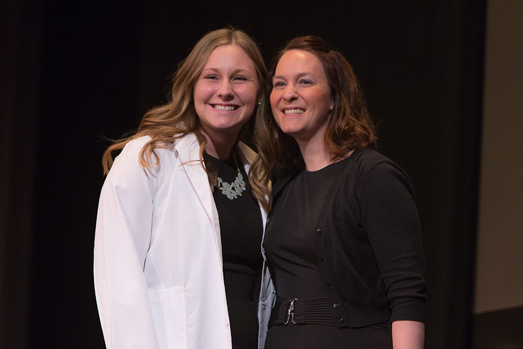 Students dress with the white coat to symbolize the achievement they have at the School.