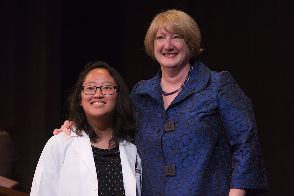 Students dress with the white coat to symbolize the achievement they have at the School.