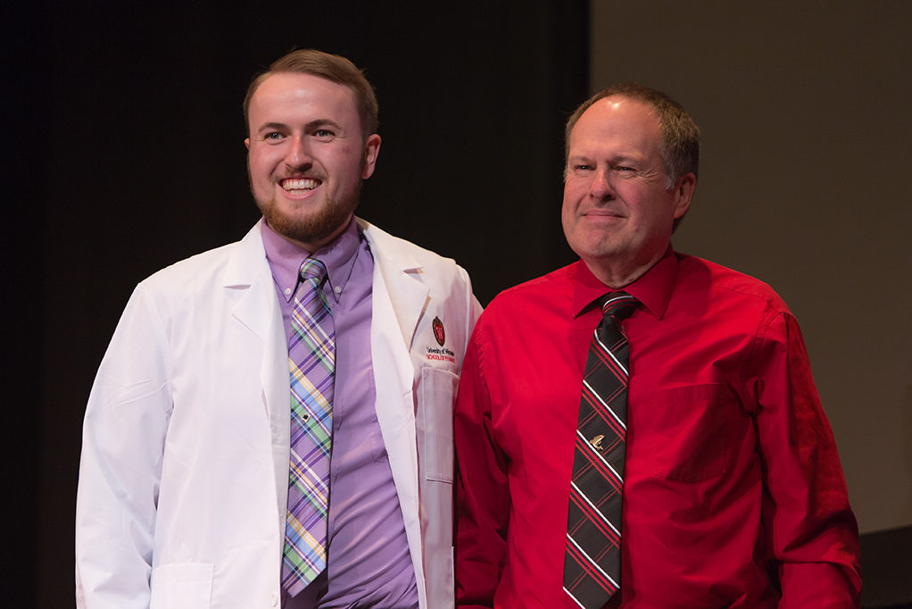 Students dress with the white coat to symbolize the achievement they have at the School.