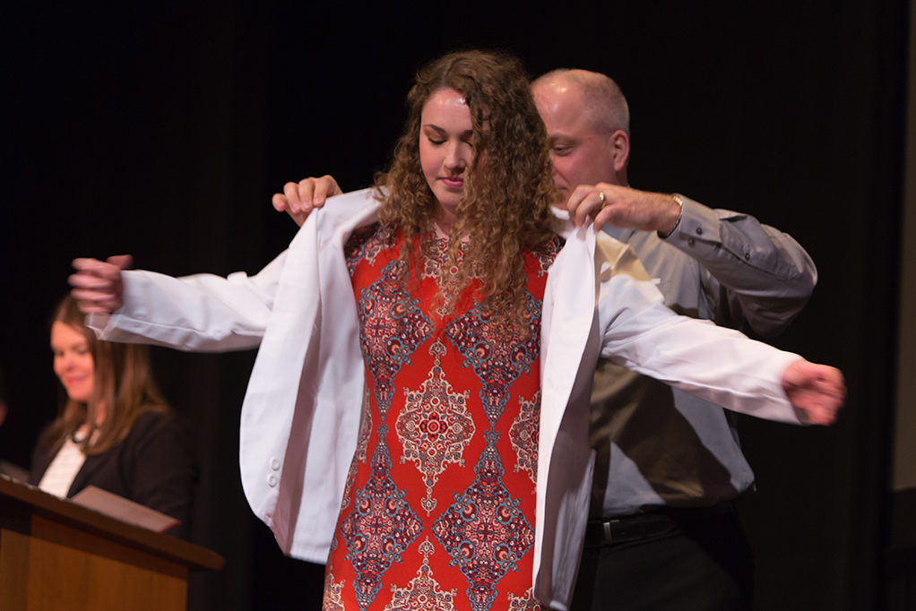 Students dress with the white coat to symbolize the achievement they have at the School.