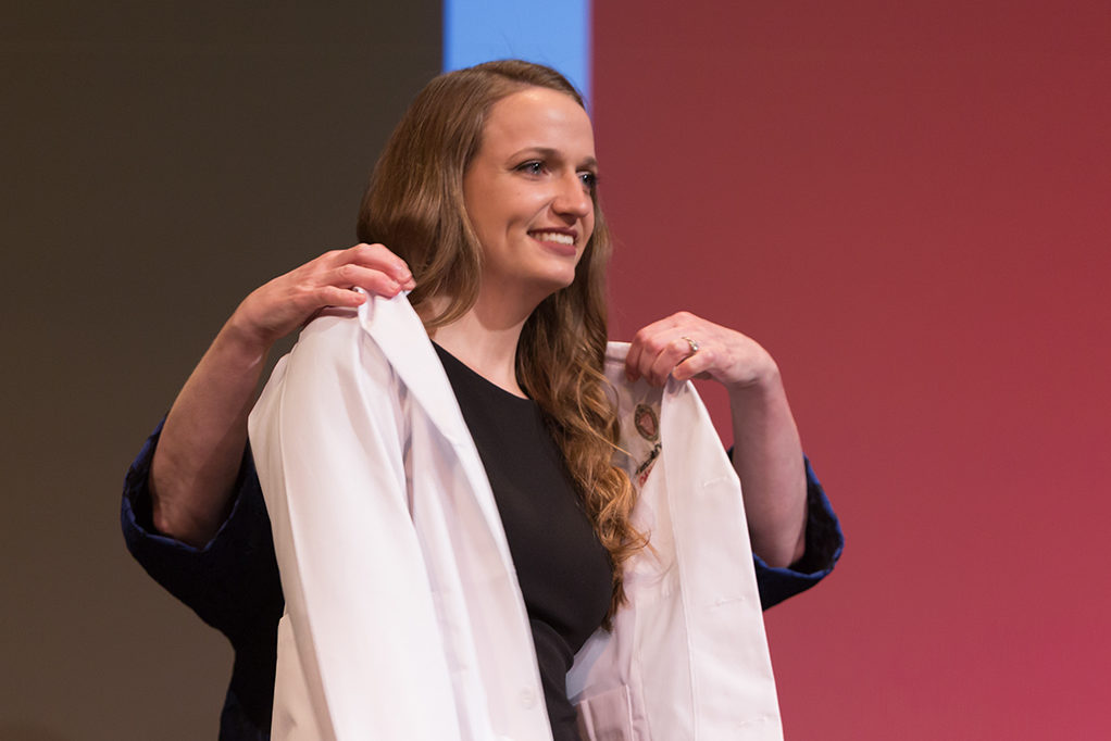 Students dress with the white coat to symbolize the achievement they have at the School.