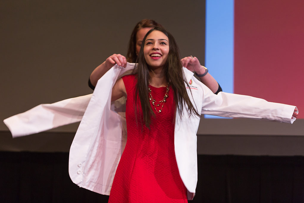 Students dress with the white coat to symbolize the achievement they have at the School.