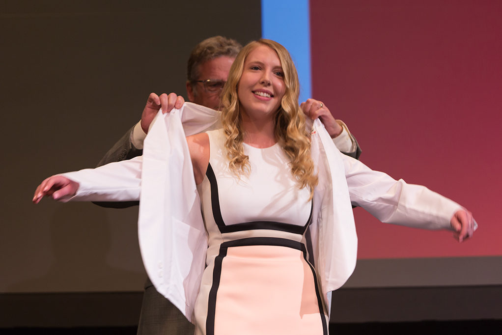 Students dress with the white coat to symbolize the achievement they have at the School.