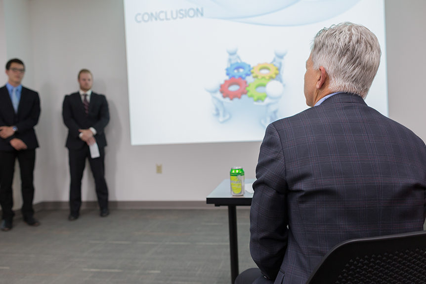 faculty listening to presenters during SHARx tank event