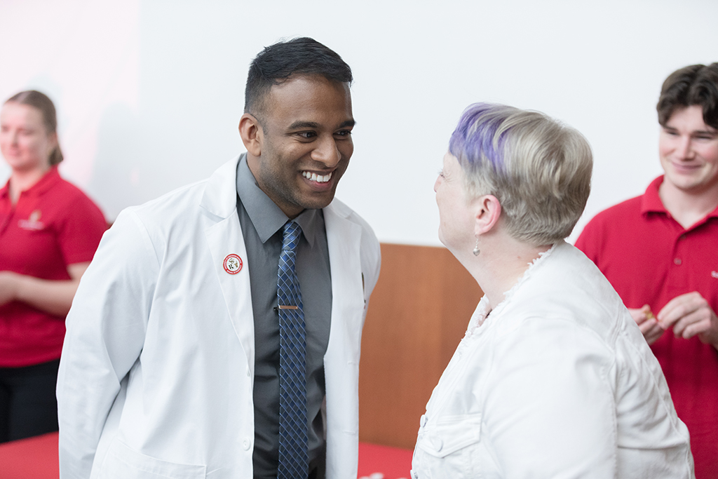 PharmD student Mathawan Balakrishnan receives his pin from Associate Professor Karen Kopacek. | Photo by Todd Brown