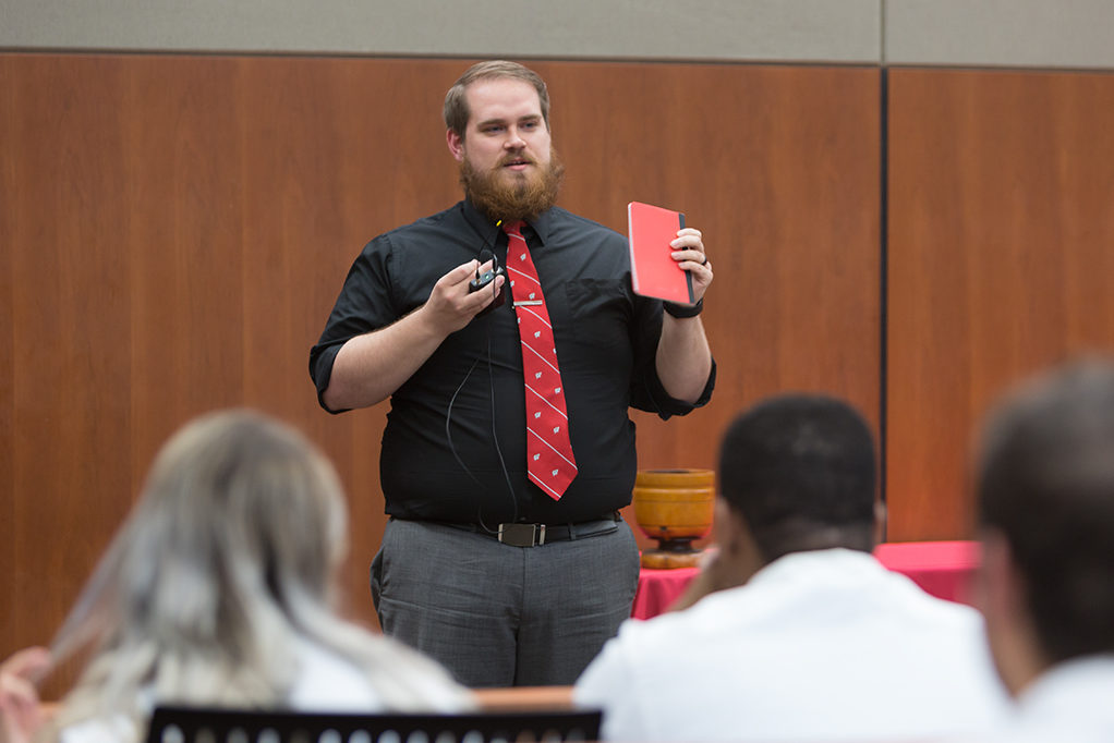 Brock Dantuma, fourth year student pharmacist, speaks to the class about his experience and lesson from the School.