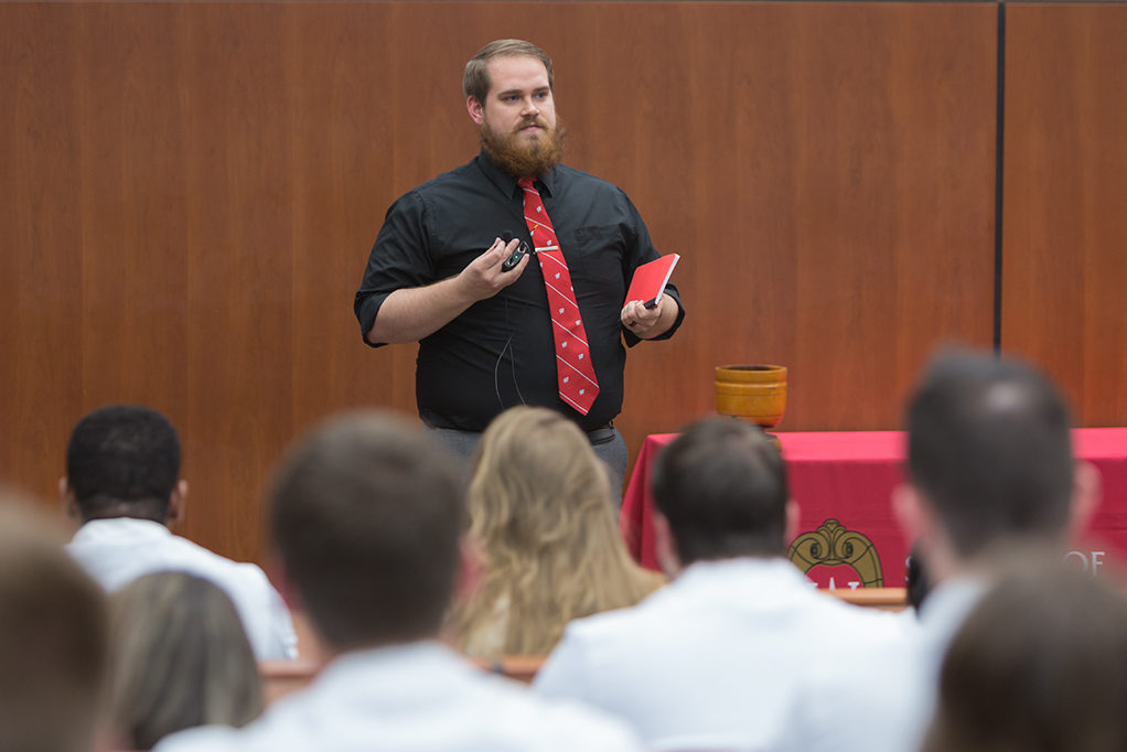 Brock Dantuma, fourth year student pharmacist, speaks to the class about his experience and lesson from the School.