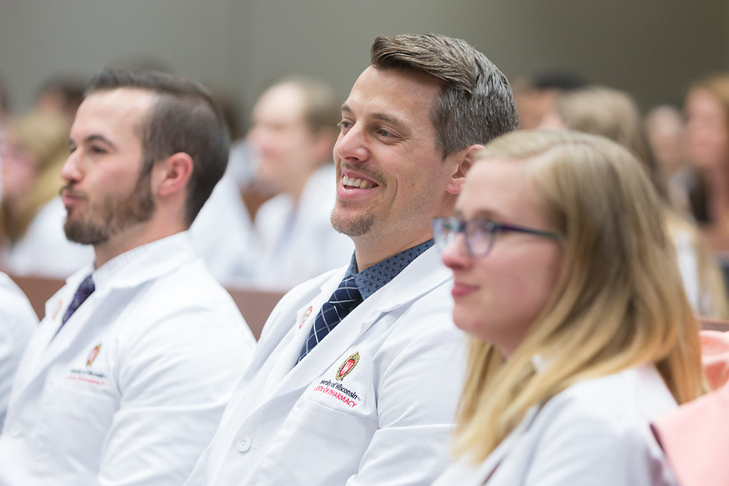 Student pharmacists are listening to the speakers.
