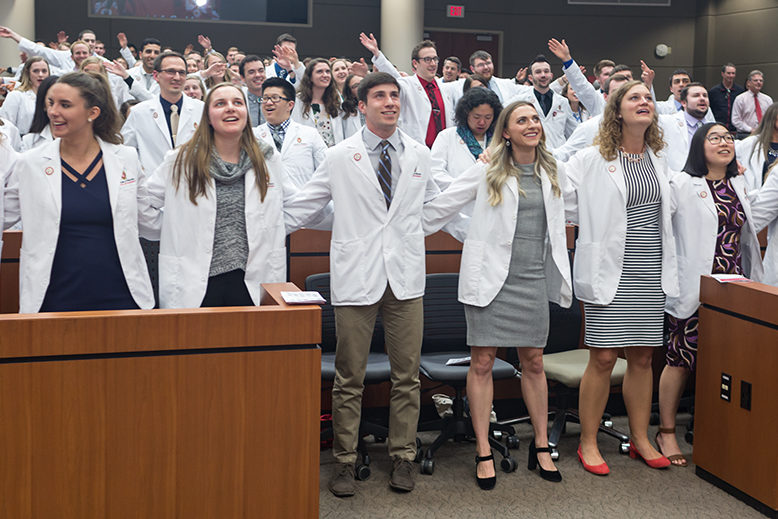 Student pharmacists locking arms during the ceremony
