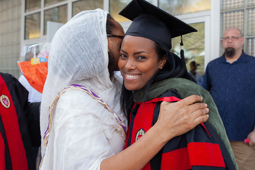 Friends and students celebrate the sweet moment.