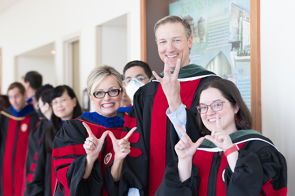 Beth Martin, John Dopp, and Amanda Margolis hold up Wisconsin W's.