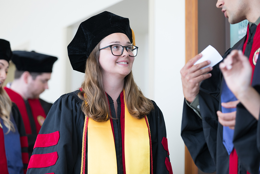 Students line the halls of the Union before the Hooding Ceremony begins.
