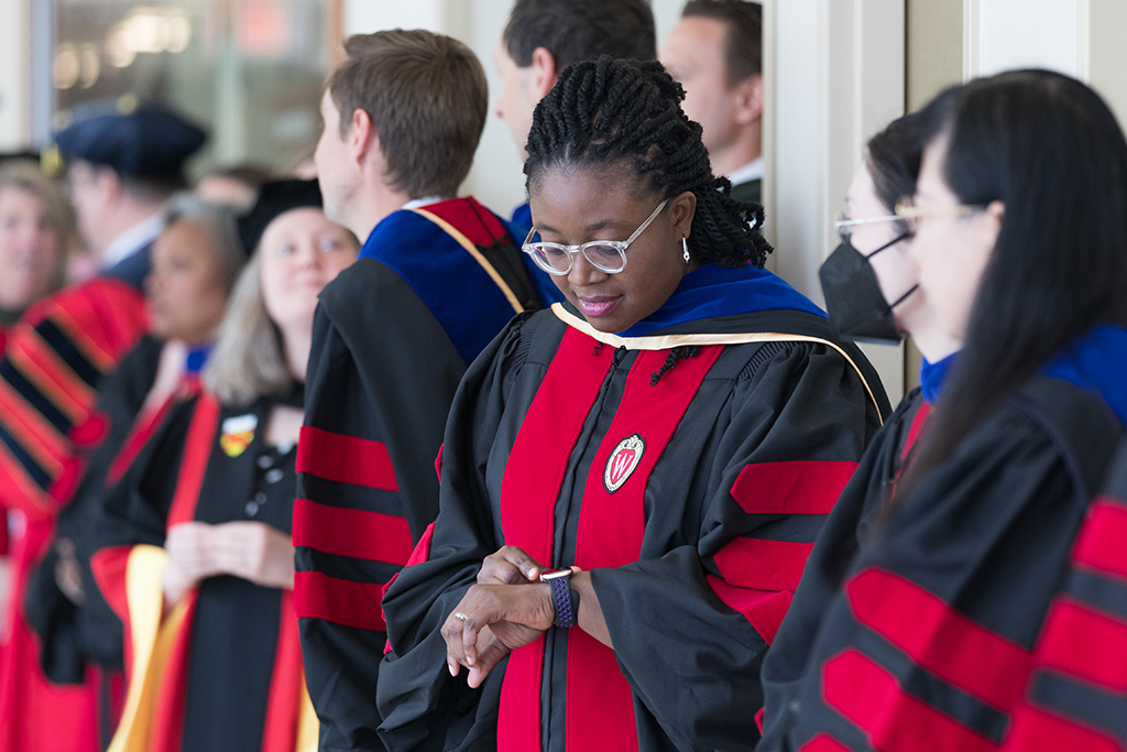 Faculty await the hooding ceremony in the hallway of the Union.