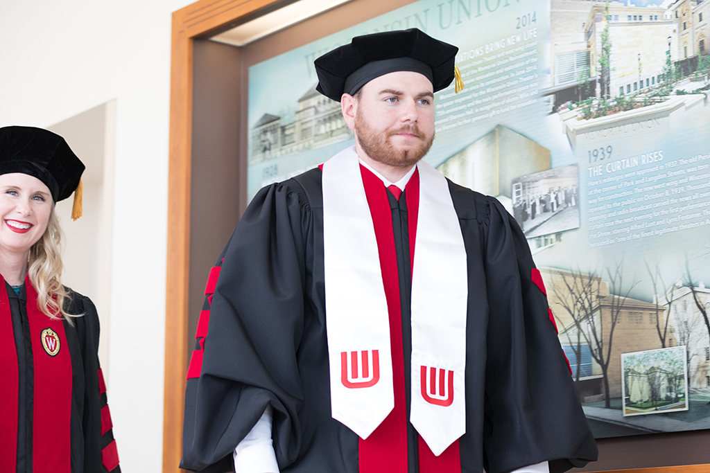 Students line the halls of the Union before the Hooding Ceremony begins.
