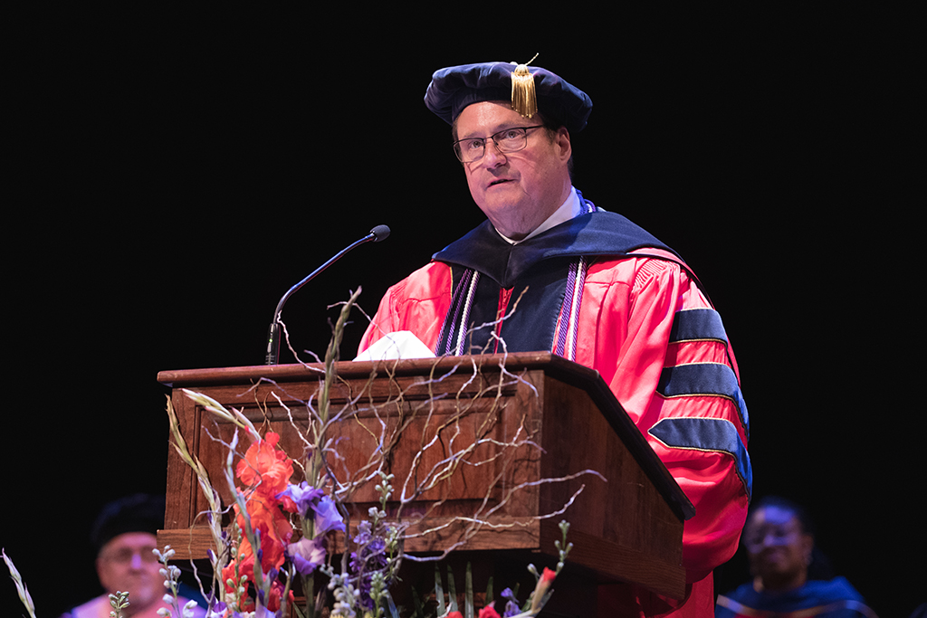 Dean Steve Swanson speaks at the podium.