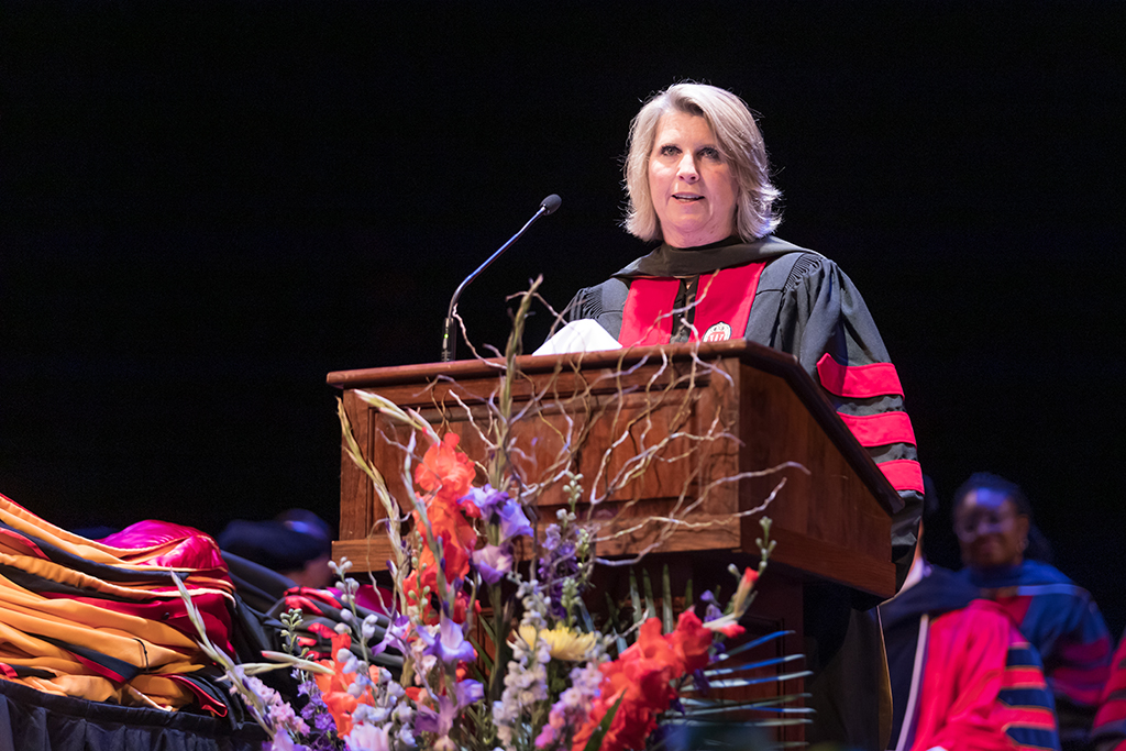 Debra Fluno speaks at the podium.