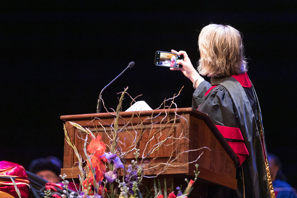 Debra Fluno takes a selfie at the podium.