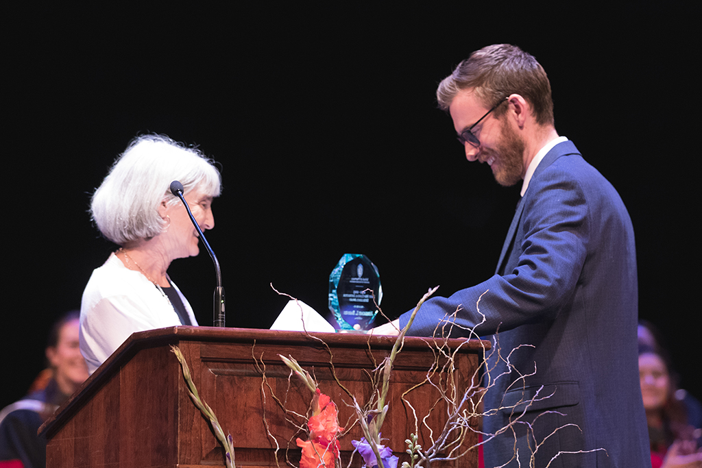 Mara Kieser gives Jeremy Barnes his Larry Boh Clinical Instructor Excellence Award.