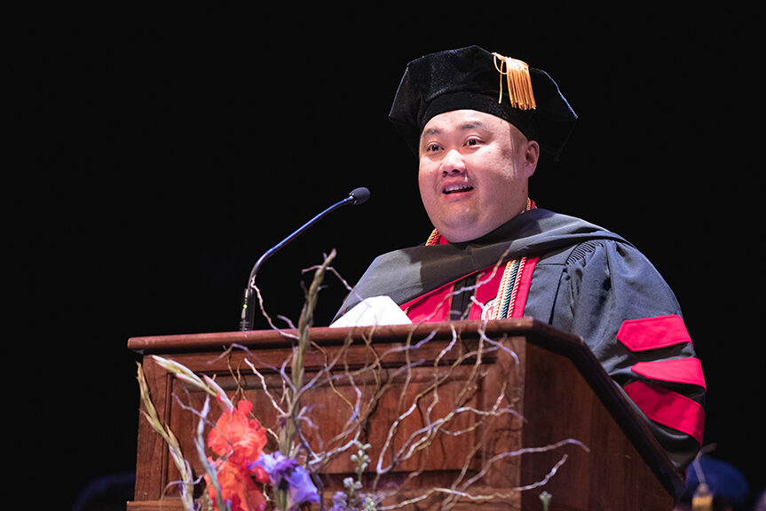 Mark Moua speaks at the podium.
