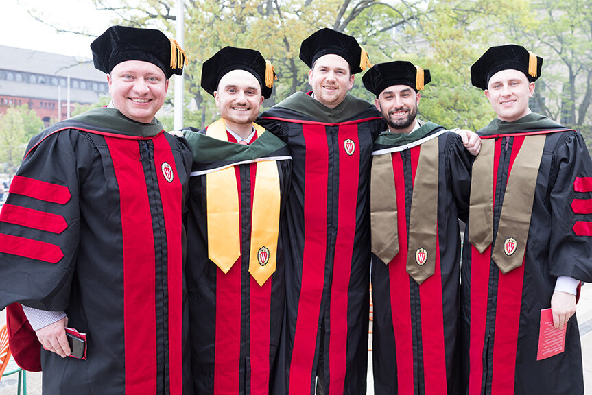 A group of graduates pose for a photo.