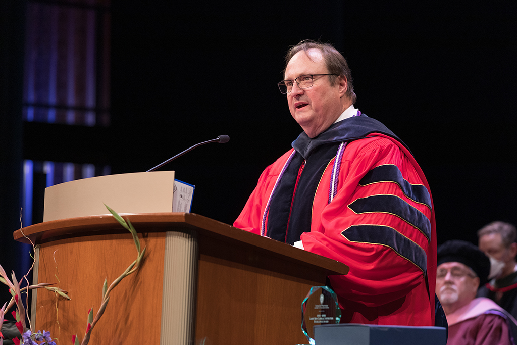 Dean Steve Swanson speaking at podium for SoP 2022 Hooding Ceremony