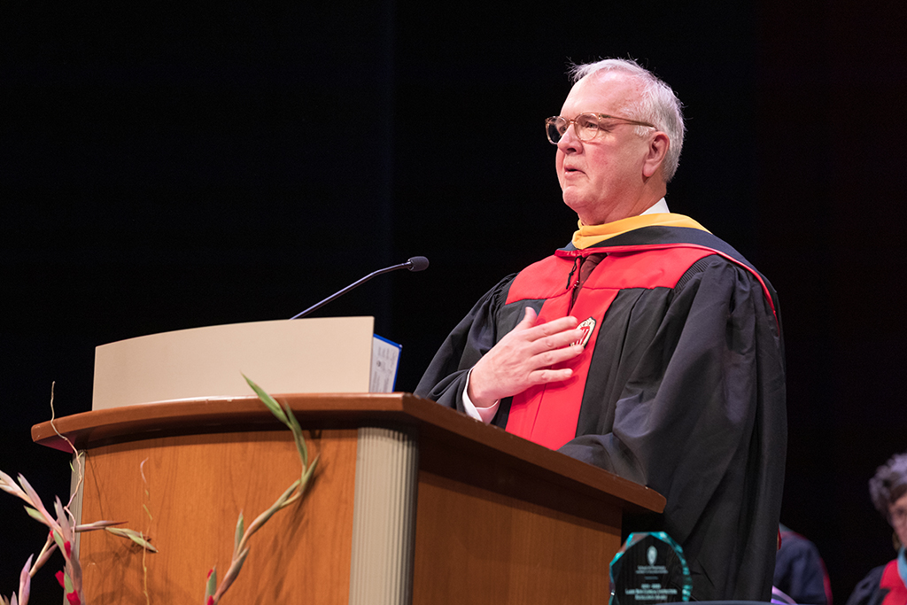 Speaker at podium for SoP 2022 Hooding Ceremony