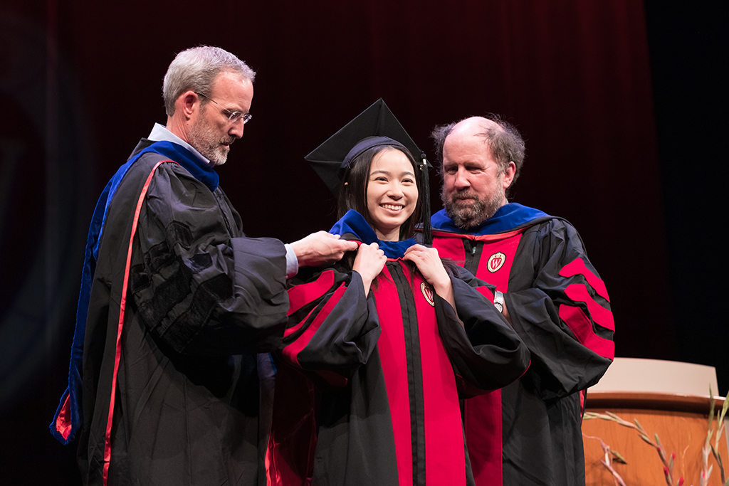 Dave Mott and Jay Ford bestowing a hood on a graduate student at the hooding ceremony