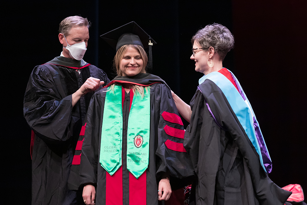 Class of 2022 PharmD graduate Megan Andraski receives her hood from Professor John Dopp and Advisor Rebecca Beebe