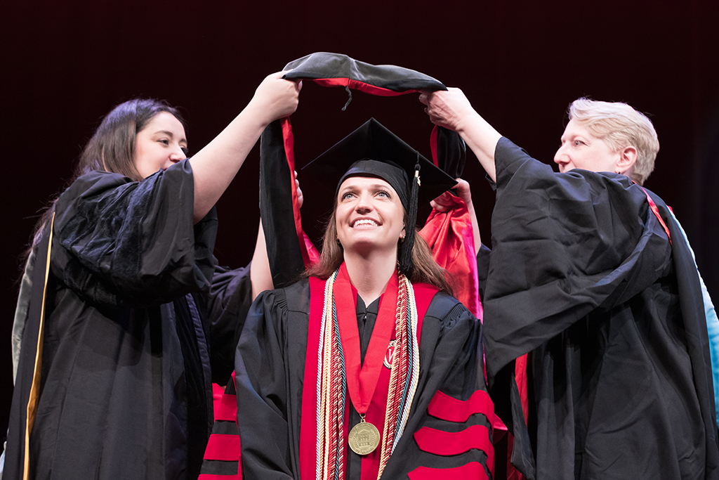 Class of 2022 PharmD graduate Brianna Groen receives her hood from professors Marina Maes and Karen Kopacek