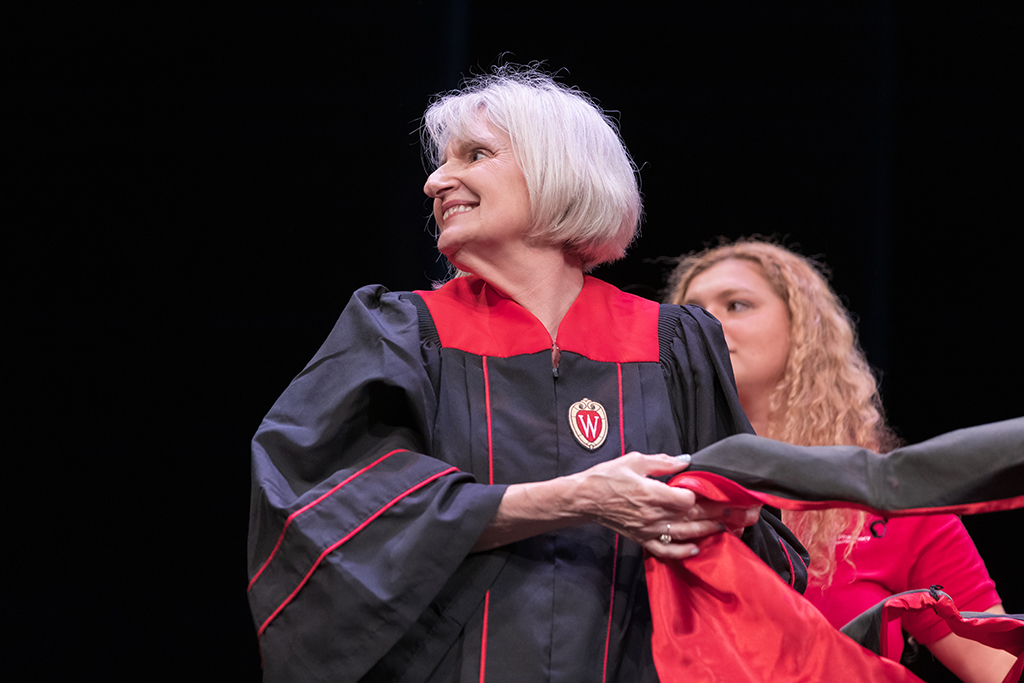 Bonnie Fingerhut holds a hood for the next recipient